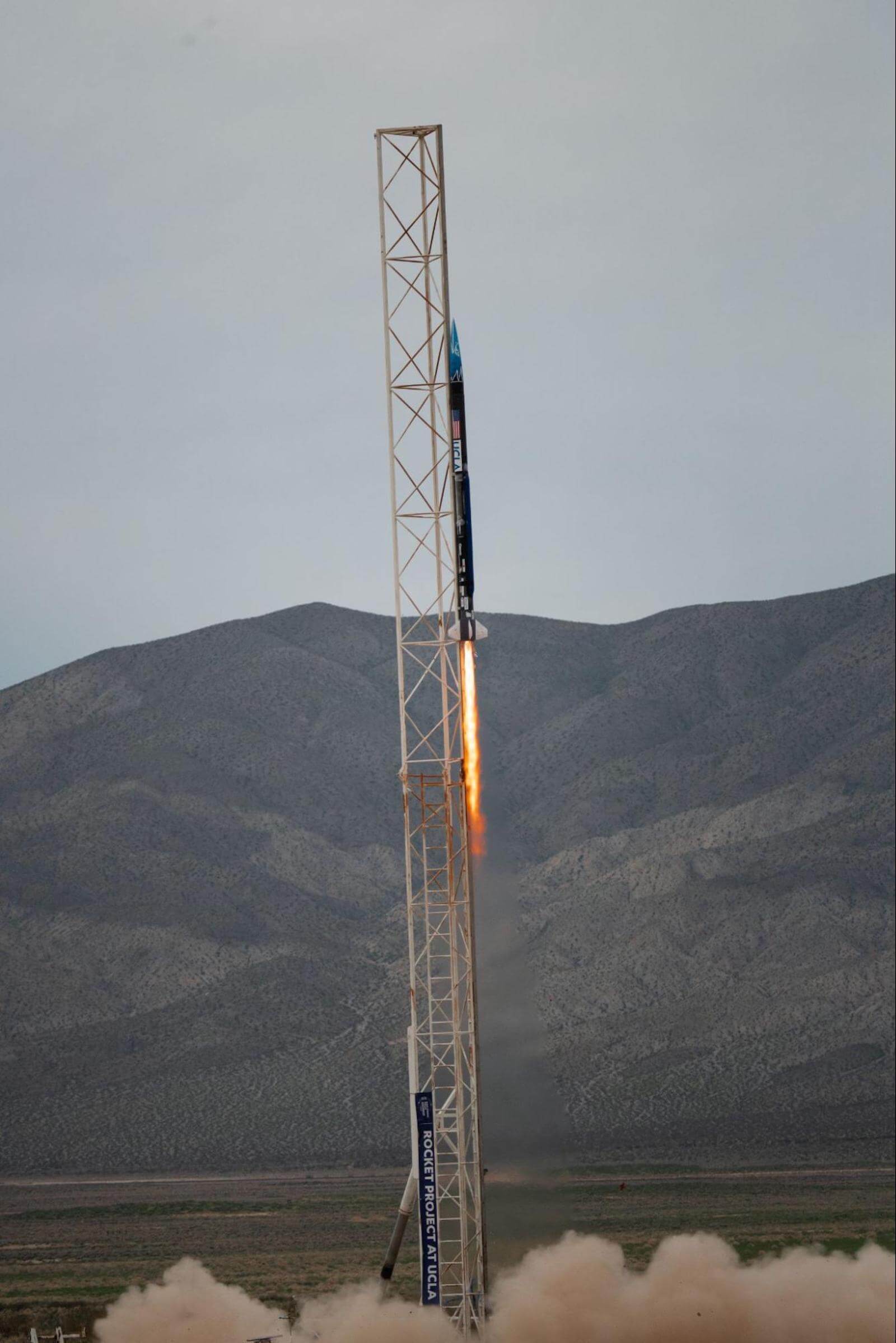 A photo of a rocket named Phoenix launching in the desert.