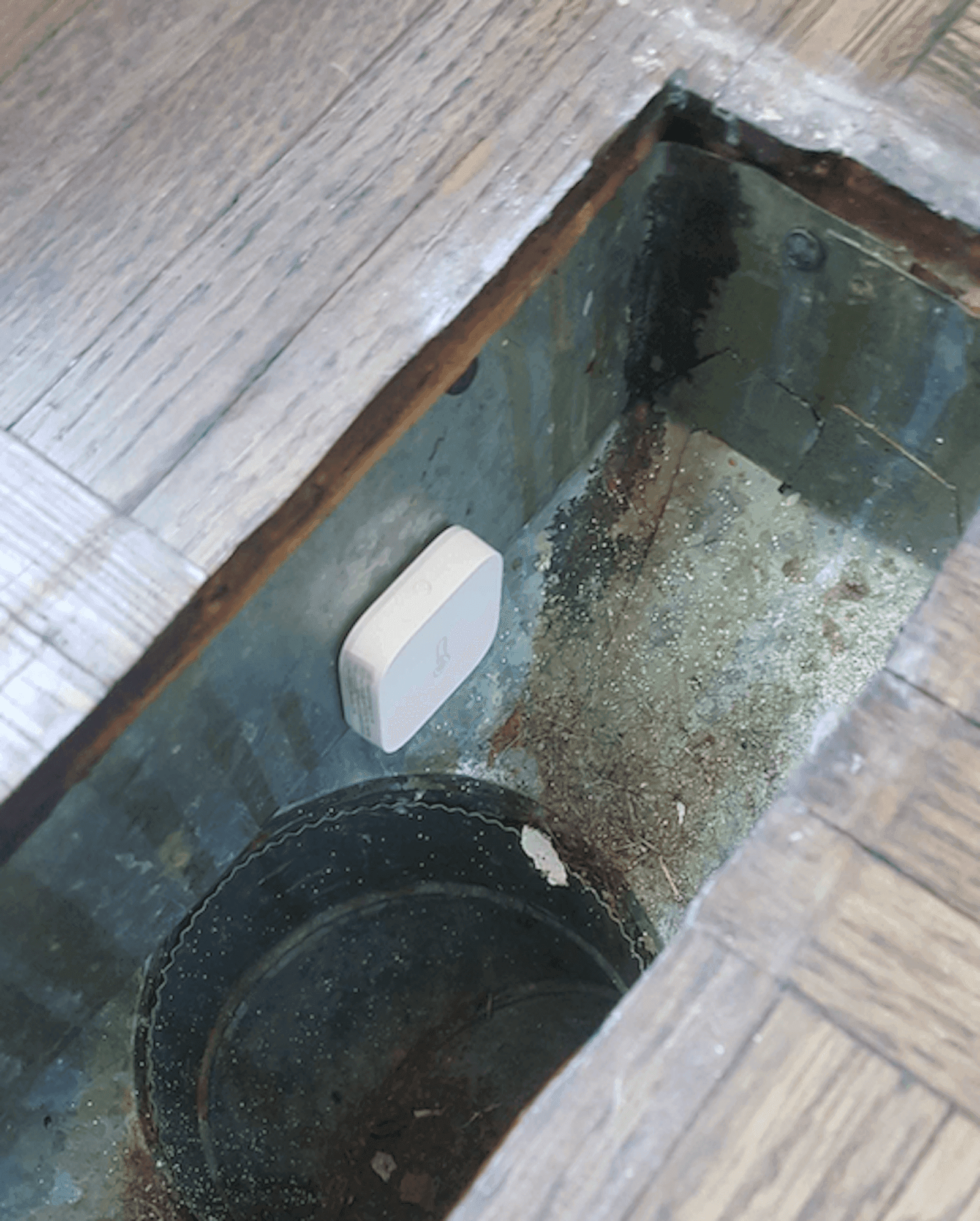 A photo of a temperature sensor mounted inside of a heating vent