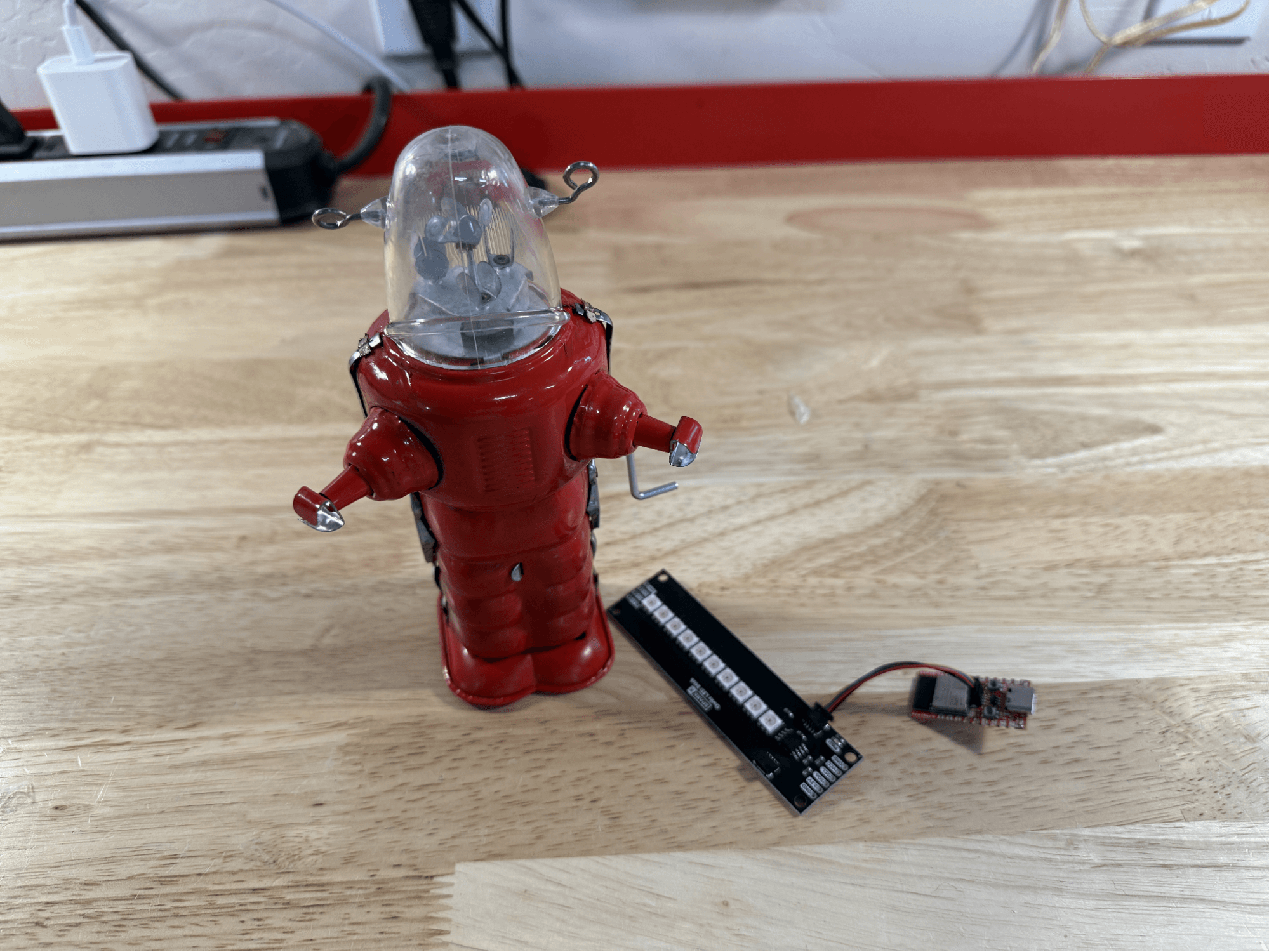 A picture of the ESP32 light panel and a small, red toy robot with a transluscent head