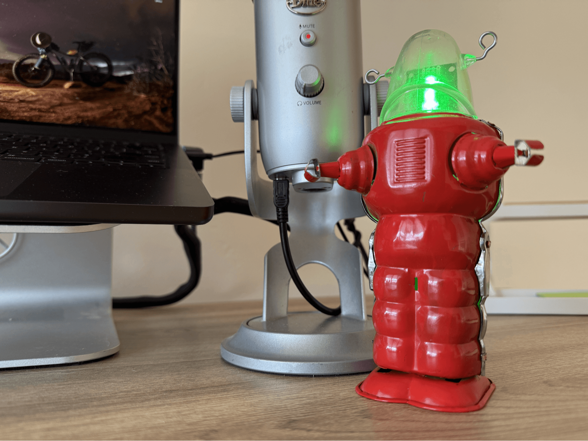 A picture of a workstation with a laptop, microphone, and IRM robot lighting up